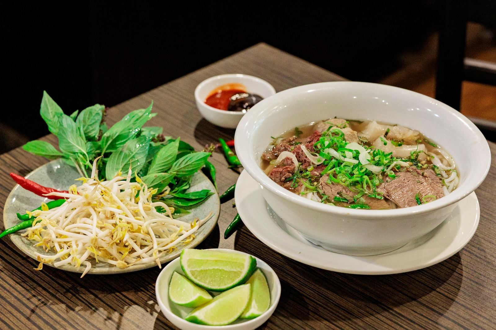Ruby Pho with herbs, bean sprouts, lime and chilli on the side