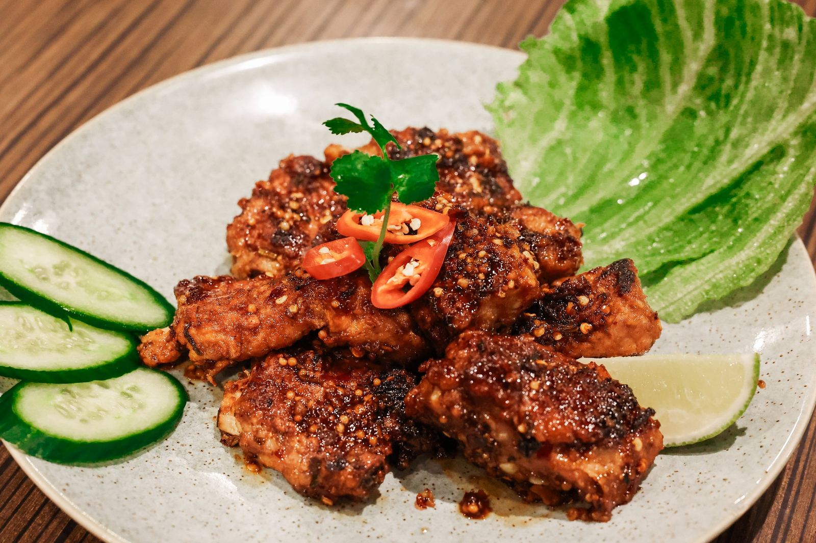 Spicy salt pork spare ribs with fresh chilli, cucumber and lettuce